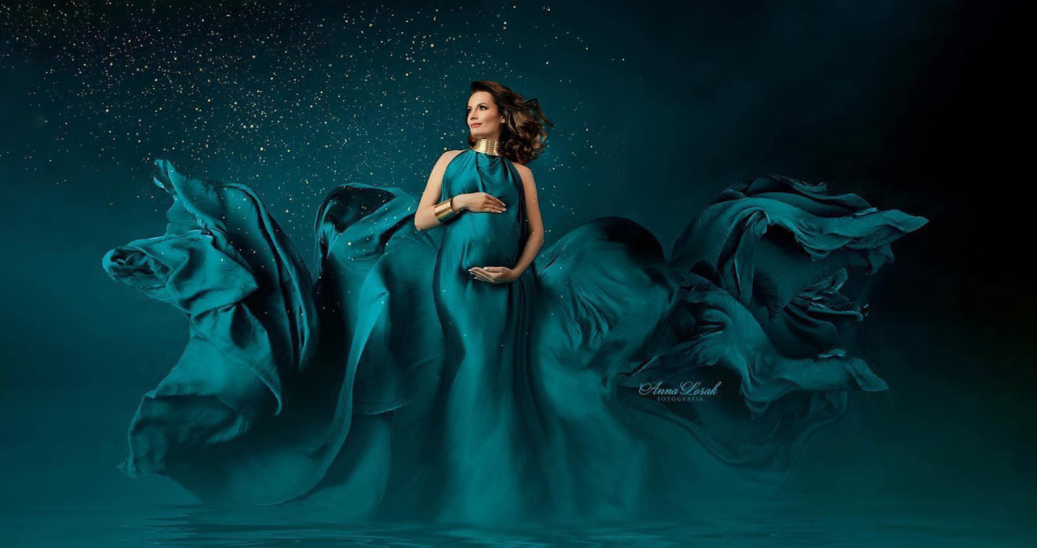 pregnant model wrapped in a long emerald silky scarf