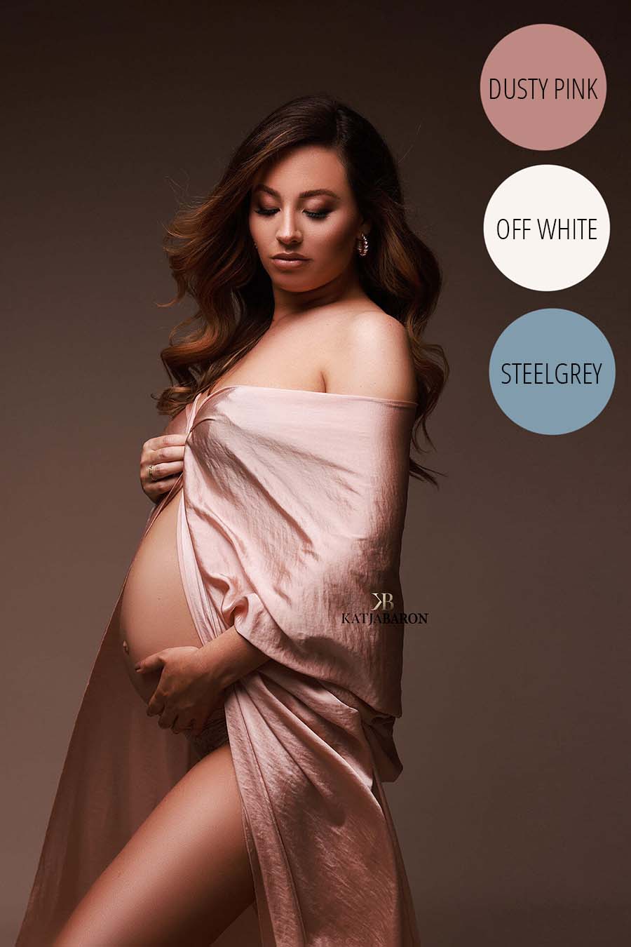 brunette model poses with her eyes closed wearing a silk scarf in dusty pink color covering her chest. her belly can be seen.