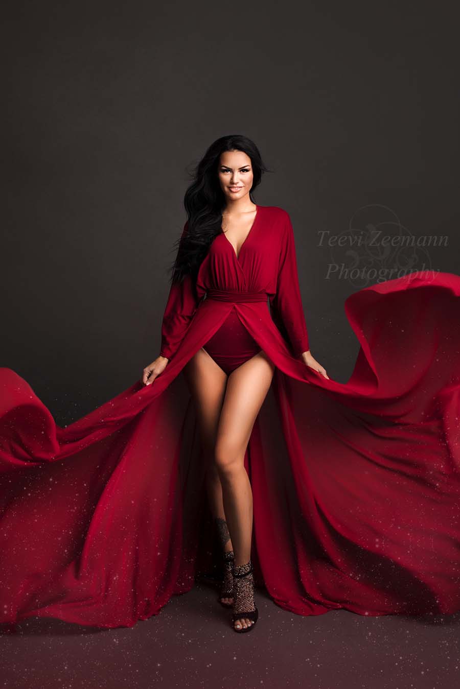 This set is a bodysuit with long sleeves with a skirt over it. The skirt has a split at the front and is made out of a light fabric. The model is wearing black glitter heels with it