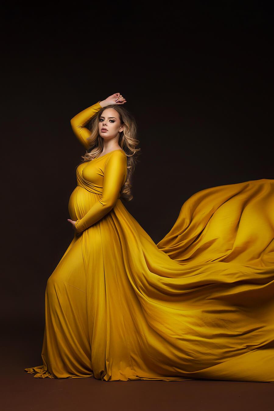 The model is wearing a long yellow dress. The skirt is verry big so in the picture is creating a long wave of dress