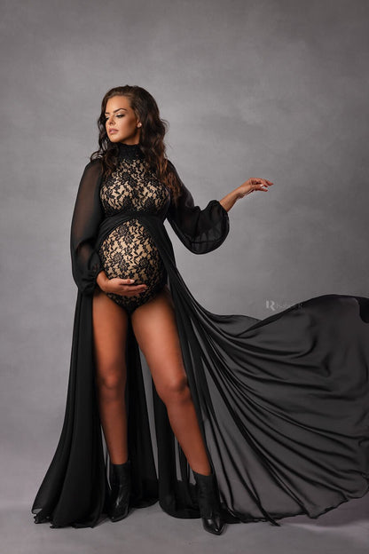 brunette pregnant model poses in a studio wearing a black lace bodysuit with chiffon sleeves and a long chiffon skirt with a split
