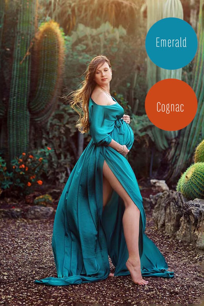 model poses outside at a cactus plantation wearing a silky cape in emerald color. 