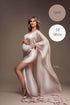 pregnant model poses in a studio wearing a silky cape in sand color. 
