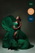 pregnant model poses in a studio wearing a dark green voile scarf with a knot tight on her chest and leaving her belly uncovered.