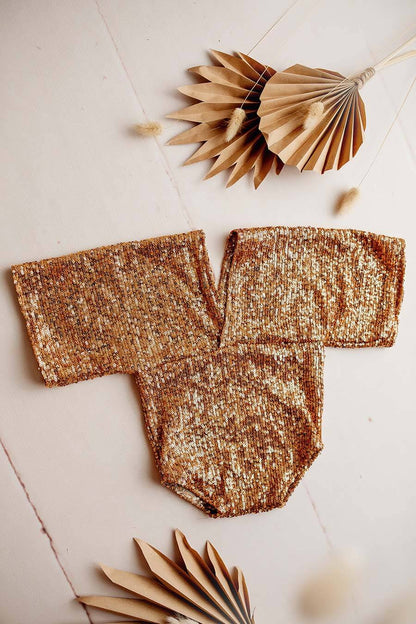 This is a product photo of the holy romper gold. The romper is part of the newborn collection of mii-estilo.