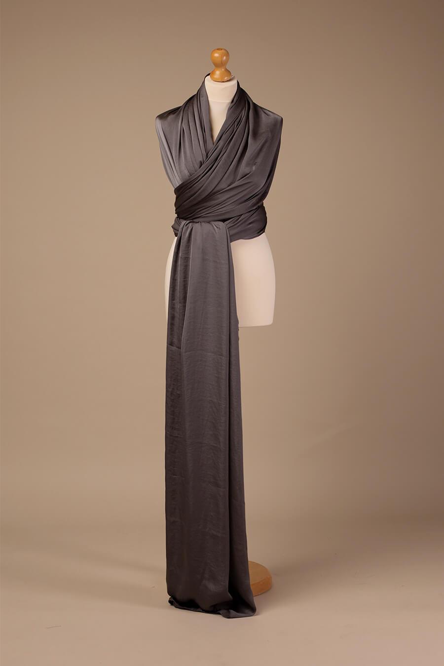 A photo of a anthracite colour scarf. it is wrapped around a stand