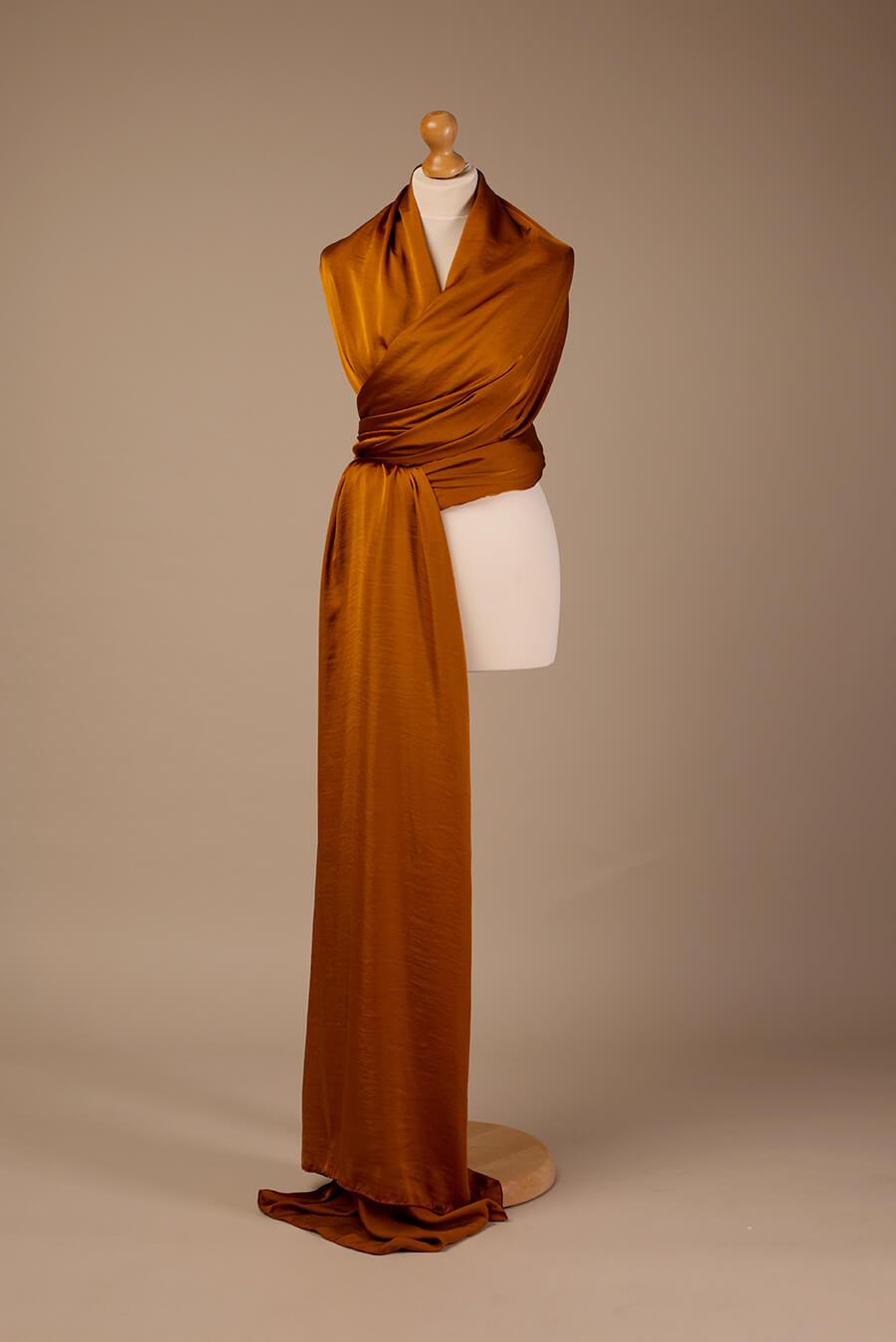 display studio photo of a 5 meter long silky cognac scarf.