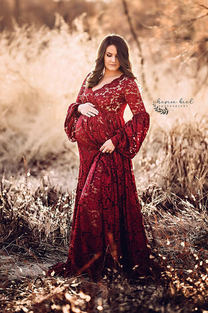 A pregnant woman with brown hair is wearing a maternity dress. The colour is bordeaux. 